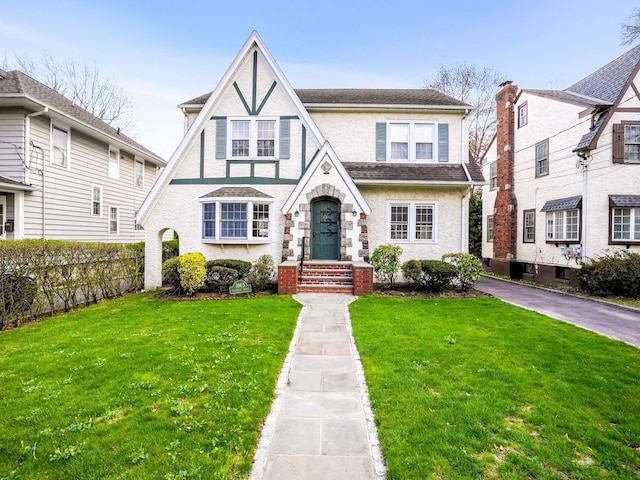 1065 Washington Ave, Pelham, NY 10803 - english style home with a front yard and stucco siding