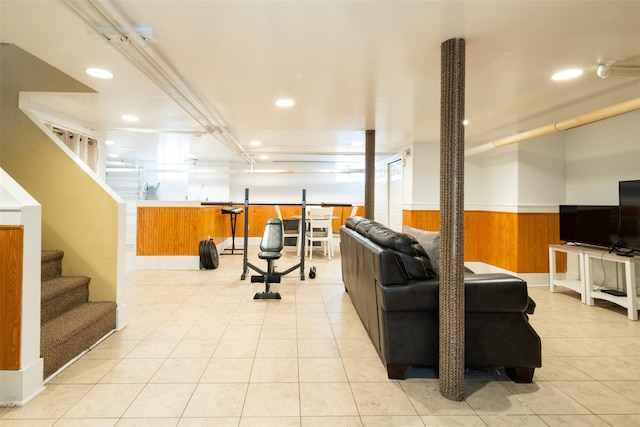 1065 Washington Ave, Pelham, NY 10803 - living room featuring recessed lighting, stairs, wainscoting, light tile patterned floors, and wooden walls