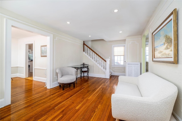 living area featuring wood finished floors, recessed lighting, and stairs