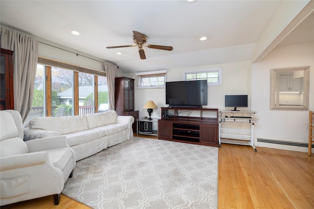 living area with a baseboard radiator, light wood finished floors, ceiling fan, and recessed lighting