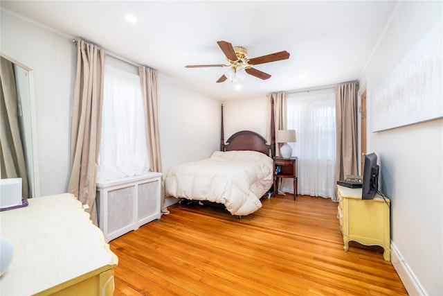bedroom featuring light wood-style flooring, recessed lighting, ceiling fan, and radiator