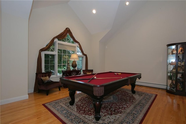 rec room featuring pool table, wood finished floors, baseboard heating, and high vaulted ceiling