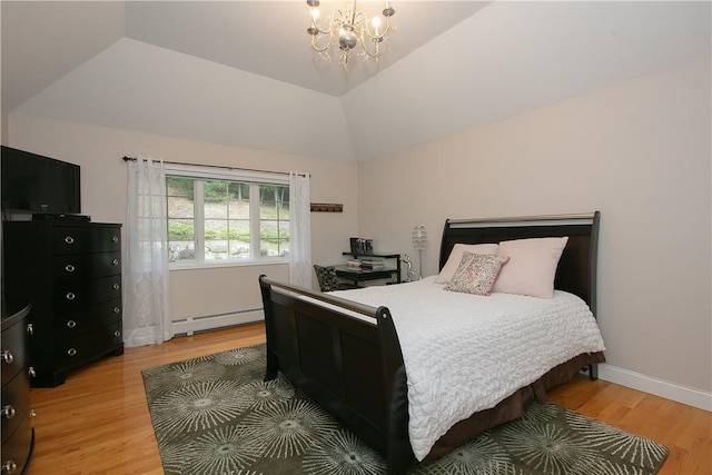 bedroom featuring baseboard heating, vaulted ceiling, baseboards, a chandelier, and light wood-style flooring