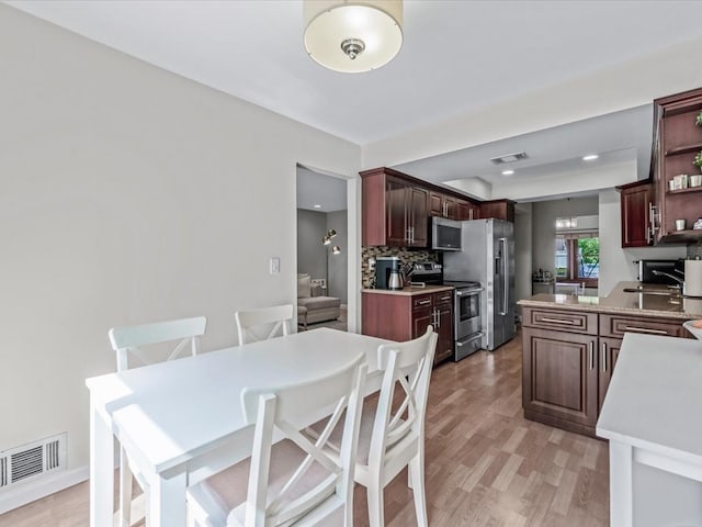 54 Hidden Ridge Dr, Syosset, NY 11791 - kitchen featuring open shelves, visible vents, backsplash, and appliances with stainless steel finishes