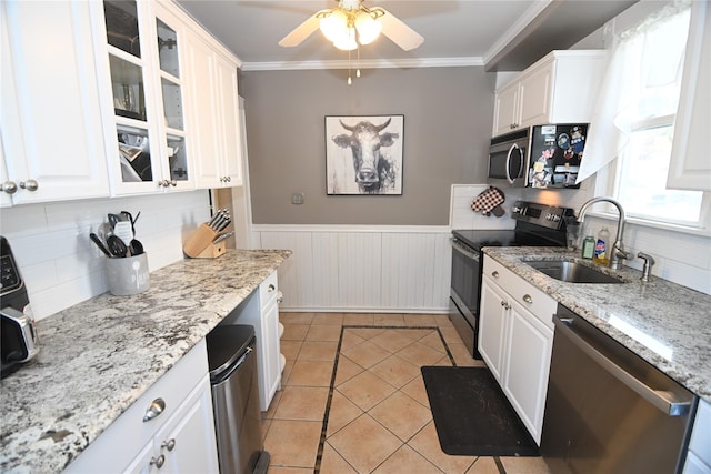 kitchen with white cabinetry, stainless steel appliances, and a sink