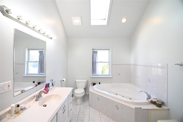 full bath featuring a whirlpool tub, lofted ceiling with skylight, toilet, and vanity
