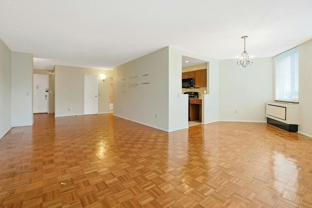 1270 N Ave Unit 3E, New Rochelle, NY 10804 - unfurnished living room featuring a chandelier and baseboards