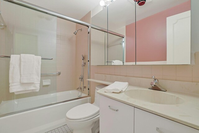 1270 N Ave Unit 3E, New Rochelle, NY 10804 - full bath with vanity, shower / bath combination with glass door, toilet, and decorative backsplash