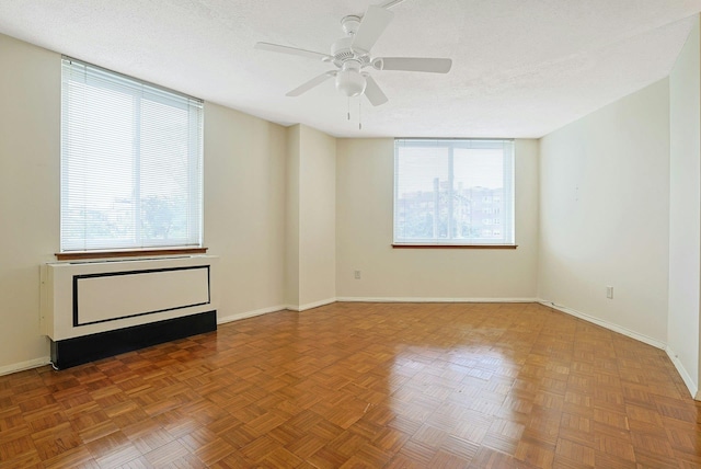 1270 N Ave Unit 3E, New Rochelle, NY 10804 - unfurnished room with plenty of natural light, baseboards, a ceiling fan, and a textured ceiling