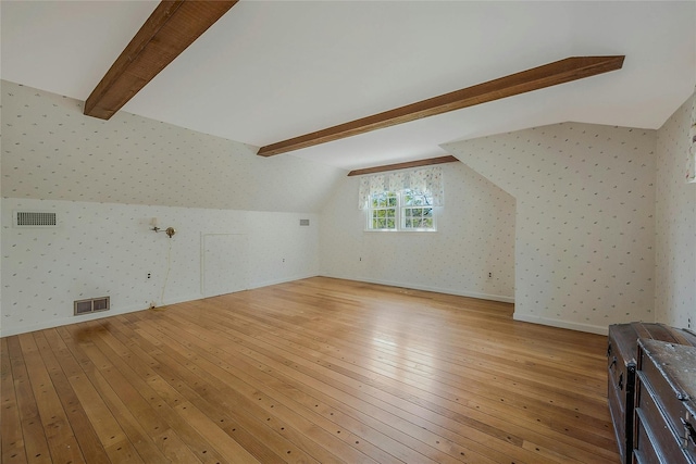bonus room with vaulted ceiling with beams, visible vents, light wood finished floors, and wallpapered walls