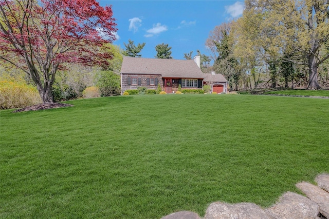 view of front of house featuring a chimney and a front yard