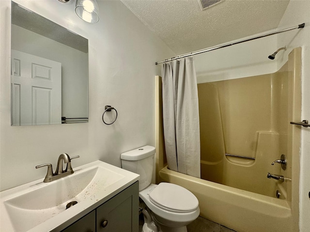 full bathroom featuring visible vents, toilet, vanity, shower / tub combo with curtain, and a textured ceiling