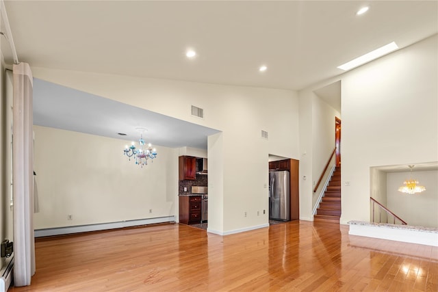 120-06 Riviera Ct Unit 17B, College Point, NY 11356 - unfurnished living room featuring a chandelier, a baseboard heating unit, light wood-type flooring, recessed lighting, and high vaulted ceiling