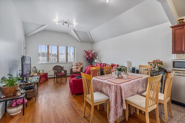 6147 Grand Ave, Maspeth, NY 11378 - dining space with lofted ceiling, wood finished floors, and baseboards