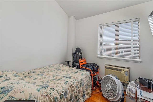 6147 Grand Ave, Maspeth, NY 11378 - bedroom with a wall mounted air conditioner, wood finished floors, and vaulted ceiling