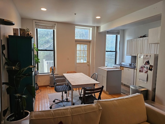 dining room featuring radiator, recessed lighting, and light wood-type flooring