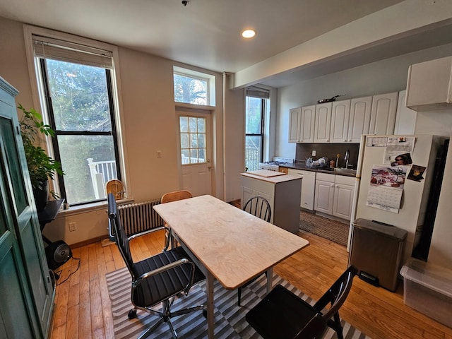 dining space featuring light wood-style flooring and recessed lighting