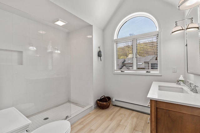 full bathroom featuring a stall shower, baseboard heating, toilet, wood finished floors, and vanity