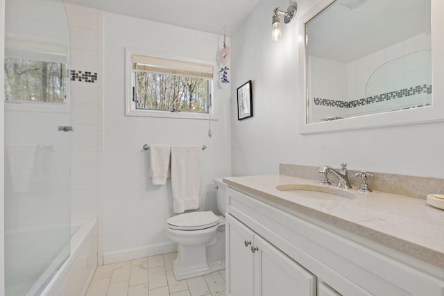 bathroom featuring toilet, vanity, and baseboards