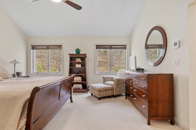 bedroom featuring light colored carpet, a ceiling fan, and vaulted ceiling