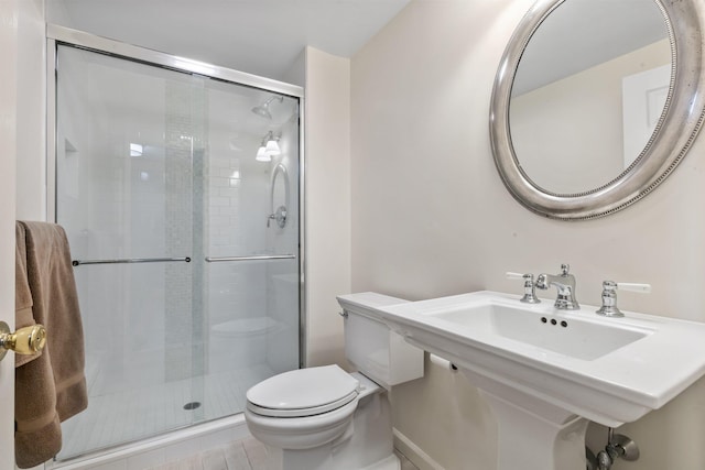bathroom with toilet and a stall shower