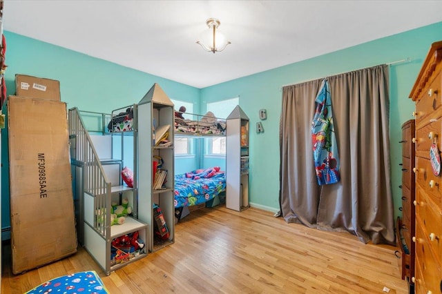 bedroom with wood finished floors and baseboards