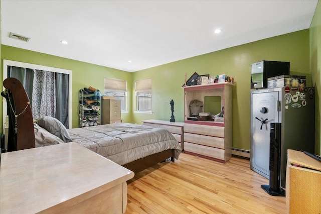 bedroom featuring recessed lighting, visible vents, a baseboard radiator, and light wood-style floors