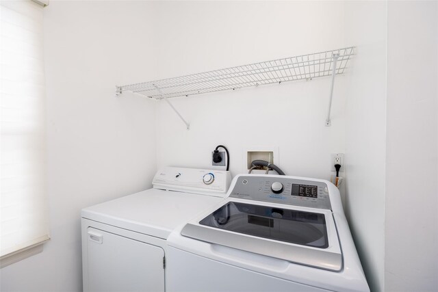 clothes washing area featuring washer and dryer