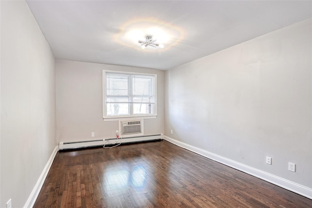 empty room with baseboard heating, baseboards, and dark wood-style flooring