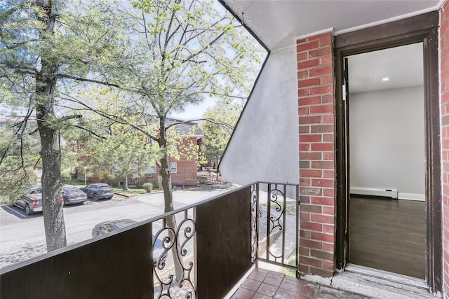 balcony featuring a baseboard heating unit