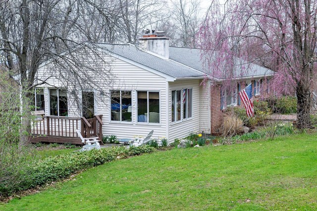 125 Tick Tock Way, Stanfordville, NY 12581 - back of house with a lawn, a chimney, a deck, and a shingled roof