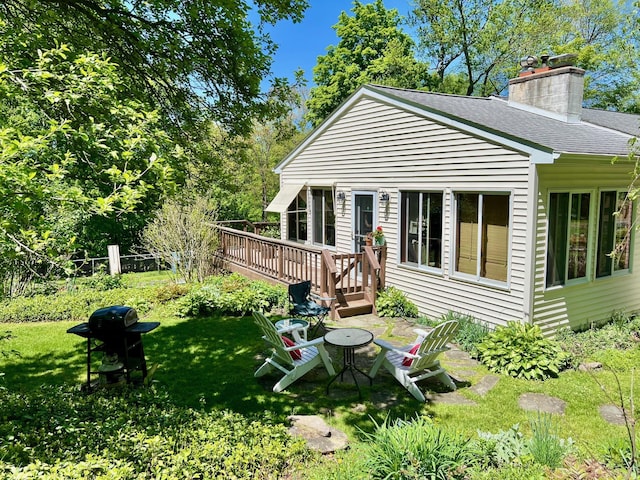125 Tick Tock Way, Stanfordville, NY 12581 - back of house featuring a wooden deck, a chimney, a shingled roof, and a yard