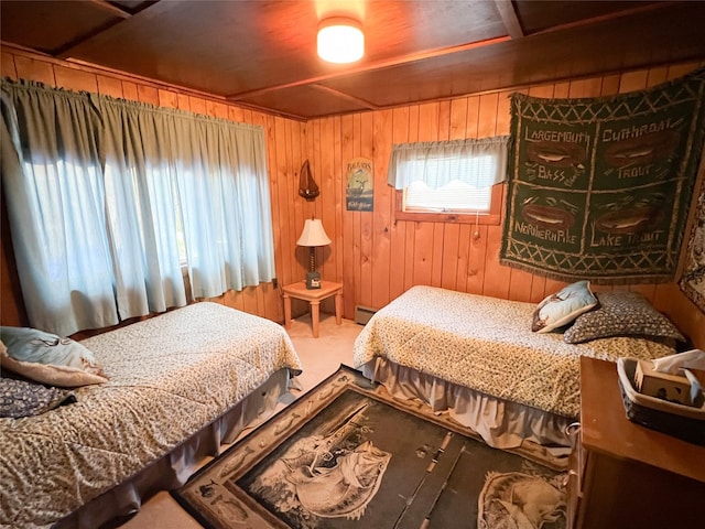 bedroom with baseboard heating, carpet floors, and wood walls