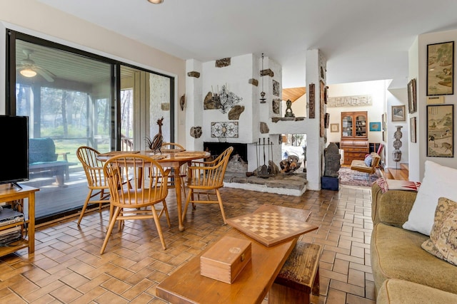 20 Schoolhouse Rd, Waccabuc, NY 10597 - dining room with a ceiling fan, a large fireplace, and brick floor