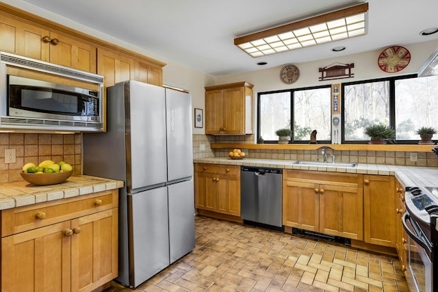 20 Schoolhouse Rd, Waccabuc, NY 10597 - kitchen featuring backsplash, tile countertops, stainless steel appliances, and a sink