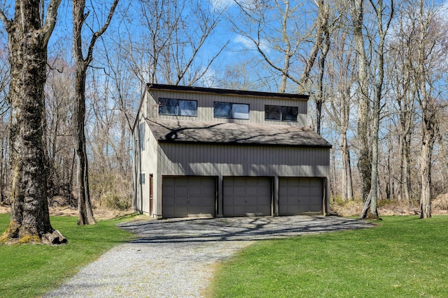 20 Schoolhouse Rd, Waccabuc, NY 10597 - exterior space featuring a front lawn, driveway, roof with shingles, and a detached garage