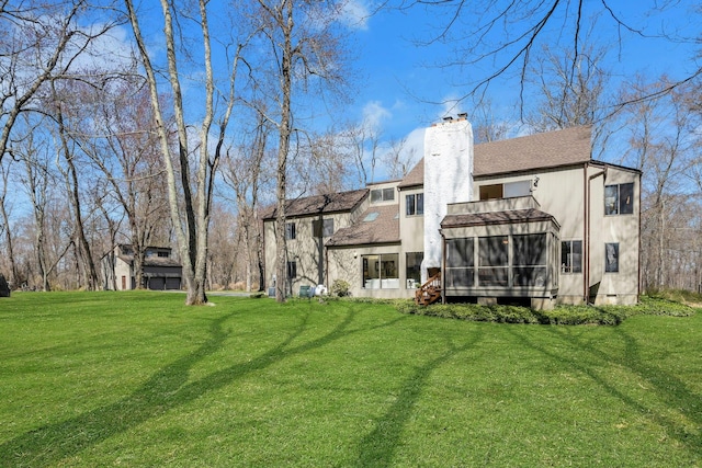 20 Schoolhouse Rd, Waccabuc, NY 10597 - rear view of house with a chimney, a sunroom, and a lawn