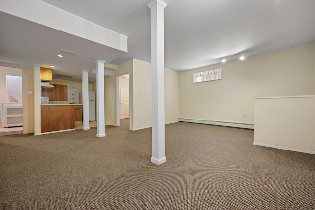 below grade area featuring baseboards, baseboard heating, carpet flooring, and freestanding refrigerator