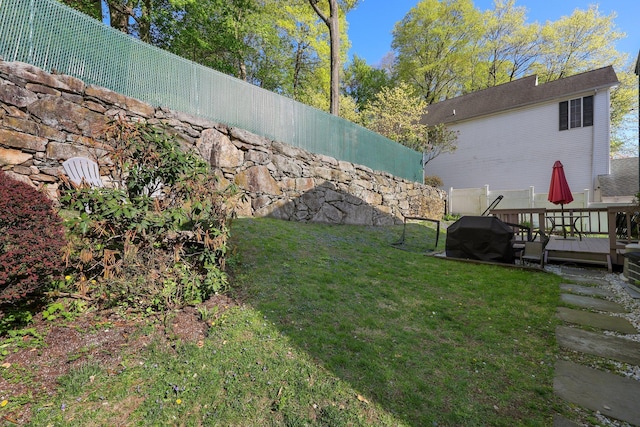 view of yard with a wooden deck and fence