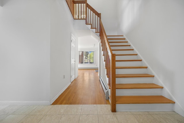 81 Pemberwick Rd Unit A, Greenwich, CT 06831 - stairs with a baseboard radiator, baseboards, and a high ceiling