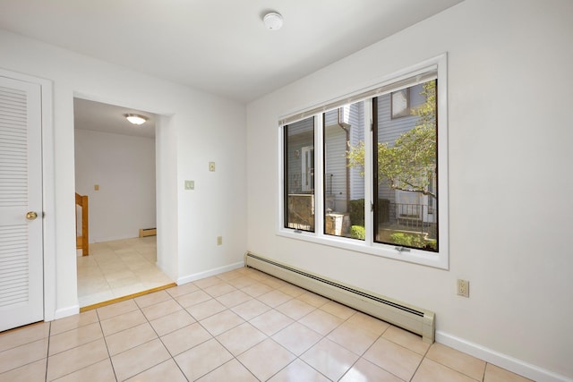 81 Pemberwick Rd Unit A, Greenwich, CT 06831 - empty room featuring a baseboard heating unit, baseboards, a baseboard radiator, and light tile patterned floors