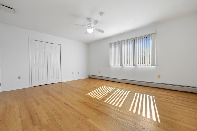 81 Pemberwick Rd Unit A, Greenwich, CT 06831 - unfurnished bedroom with a baseboard radiator, wood finished floors, a closet, and baseboards
