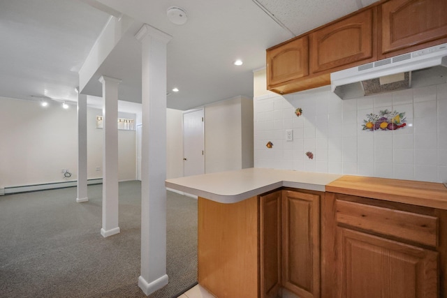 81 Pemberwick Rd Unit A, Greenwich, CT 06831 - kitchen with light countertops, under cabinet range hood, brown cabinets, and a baseboard heating unit
