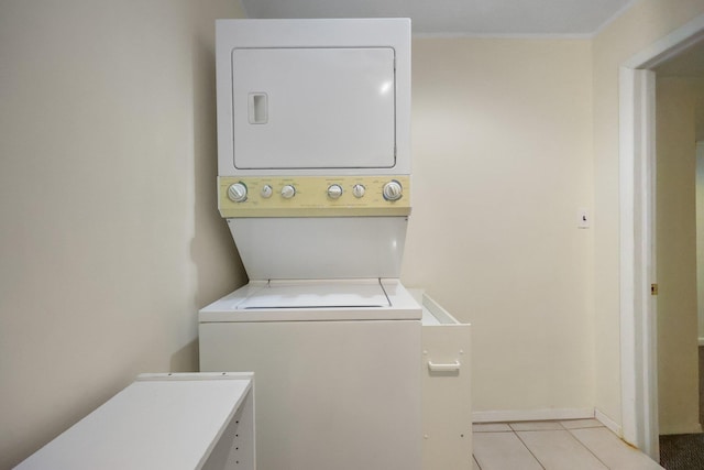 81 Pemberwick Rd Unit A, Greenwich, CT 06831 - laundry area with estacked washer and dryer, light tile patterned floors, and baseboards
