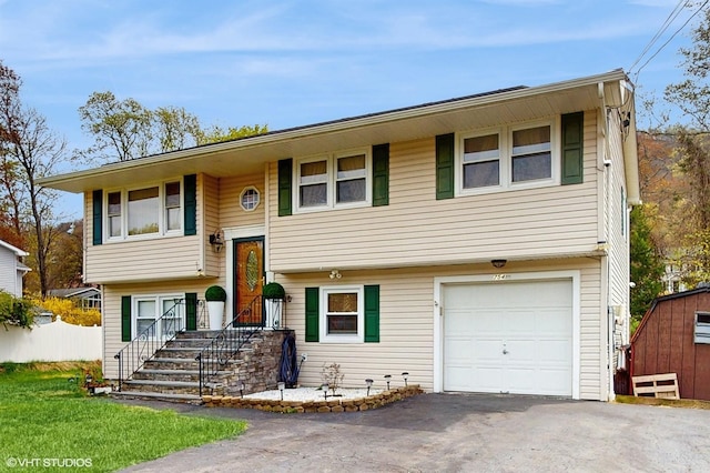754 Wolcott Ave, Beacon, NY 12508 - split foyer home featuring an attached garage and driveway