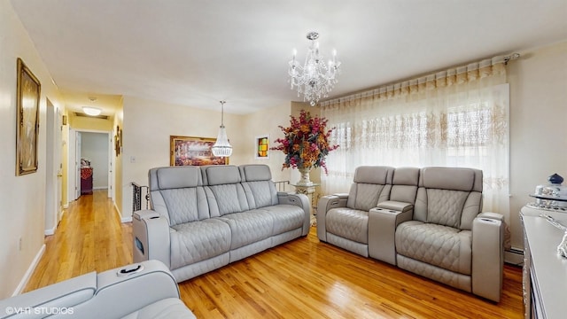 754 Wolcott Ave, Beacon, NY 12508 - living area with a baseboard radiator, light wood finished floors, baseboards, and an inviting chandelier