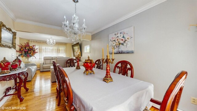 754 Wolcott Ave, Beacon, NY 12508 - dining room with light wood-style flooring, ornamental molding, and a notable chandelier