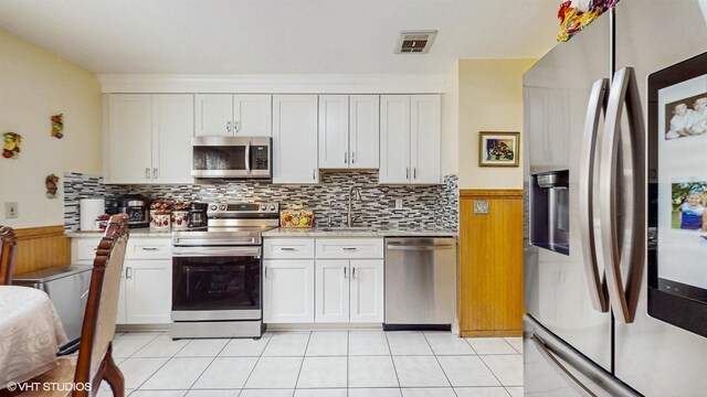 754 Wolcott Ave, Beacon, NY 12508 - kitchen featuring white cabinets, light countertops, a sink, and appliances with stainless steel finishes