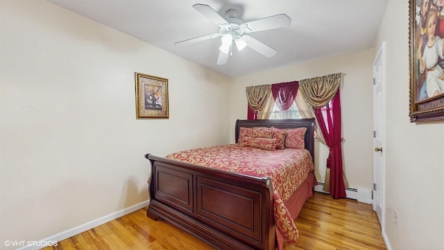 754 Wolcott Ave, Beacon, NY 12508 - bedroom featuring light wood-style flooring, baseboards, ceiling fan, and baseboard heating