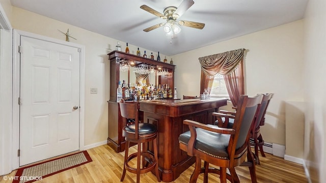 754 Wolcott Ave, Beacon, NY 12508 - bar featuring a dry bar, baseboards, light wood-style floors, and a ceiling fan